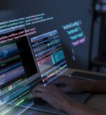 programming-background-with-person-working-with-codes-computer